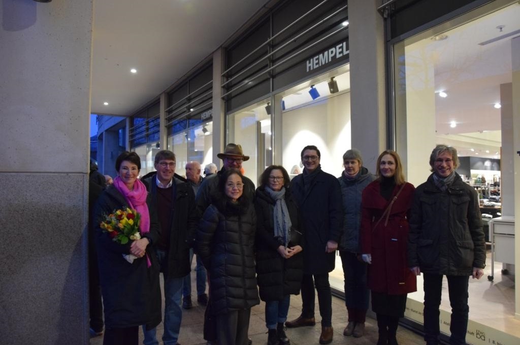 Members of the studio community in front of the glass façade of the Hempel fashion house